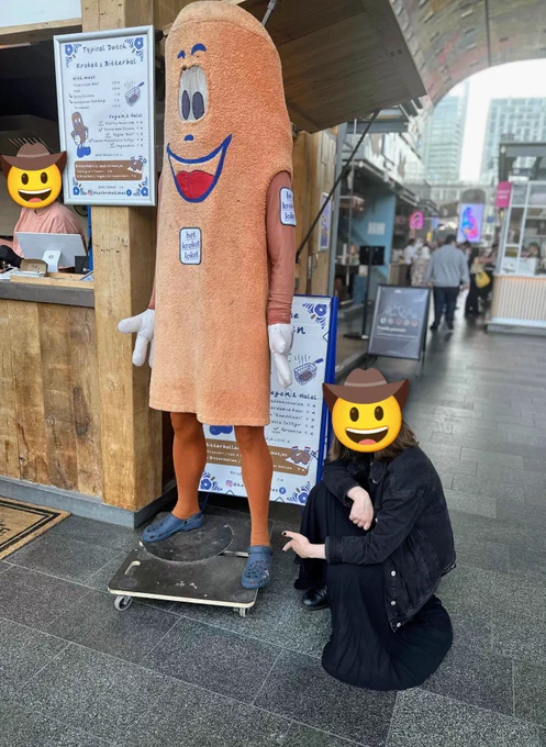 A woman in dark clothing pointing at the Crocs.