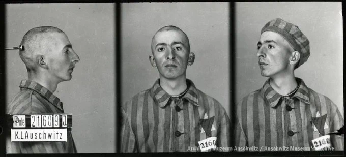 A mugshot registration photograph from Auschwitz. A man with a shaved head wearing a striped uniform photographed in three positions (profile and front with bare head and a photo with a slightly turned head with a hat on). The prisoner number is visible on a marking board on the left.
