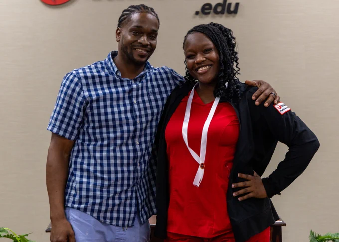 Student poses with family at nursing pinning ceremony
