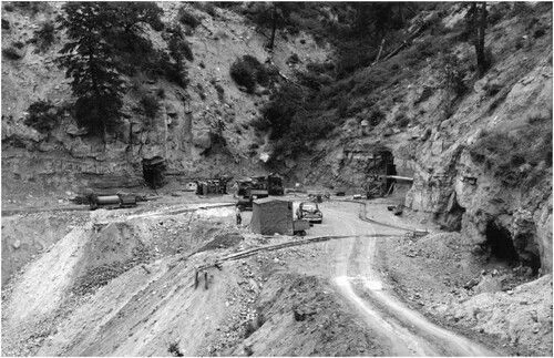 Wero & Martin 2021. Navajo uranium miners working at an unknown mountainside mine in the Cove Mining District circa 1955. Note the presence of a single “office” tent, four open mine adits/portals leading to underground workings, two narrow gauge rail lines, associated heavy equipment, spoil piles, and single access road (Photo by Milton Snow, Series NG6, courtesy of the Navajo Nation Museum Archives, Milton Snow Collection).
