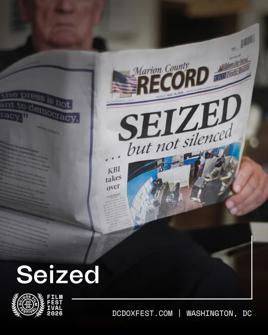 A person is holding a newspaper titled "Marion County Record" with the main headline "Seized but not silenced." The image includes a logo for the DC/DOX Film Festival at the bottom, with the text "DCDOXFEST.COM | Washington, DC."
