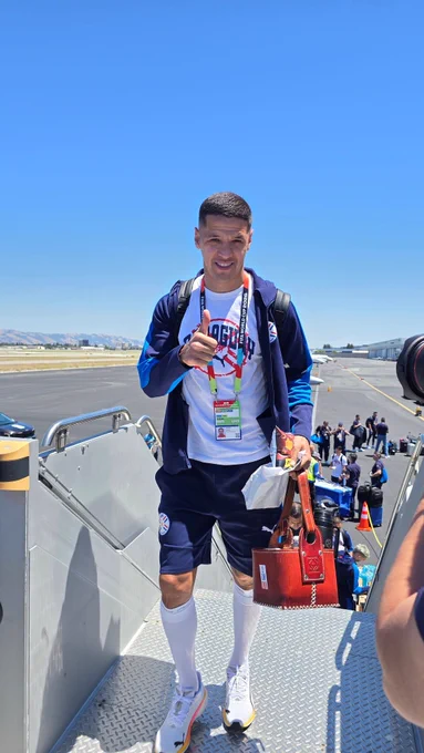 A soccer player from Team Paraguay board a plane at San Jose Mineta International Airport. 