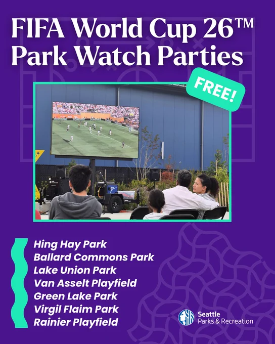 People watching a live FIFA World Cup match on a large outdoor screen at a park event hosted by Seattle Parks & Recreation.