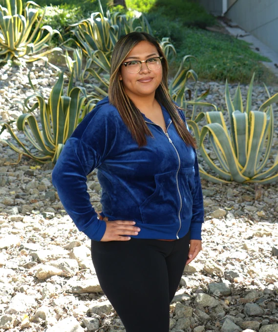 A student stands outside on campus