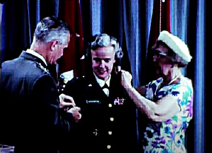 Gen. Westmoreland pins a general's star on Elizabeth P. Hoisington. He kissed her just moments later.