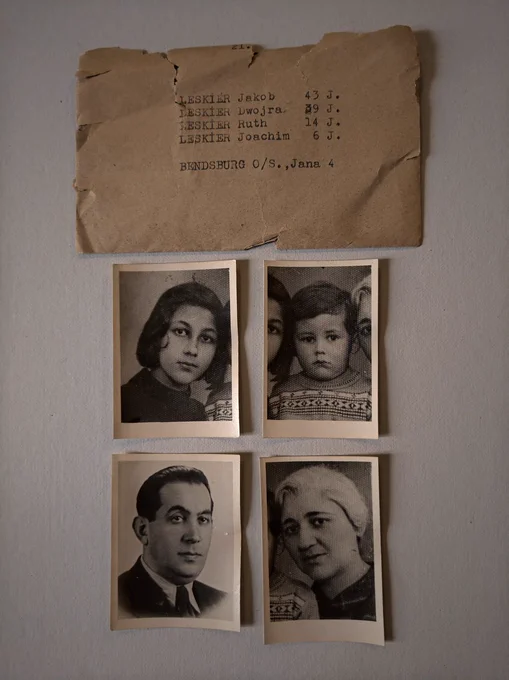 An old, torn envelope with handwritten names and ages listed above four black-and-white portrait photographs. The photographs depict two adults and two children. The envelope text includes names.