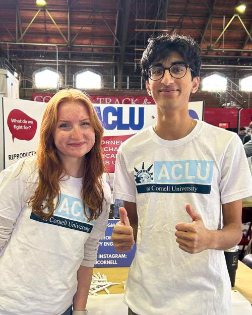 Two people wearing ACLU t-shirts