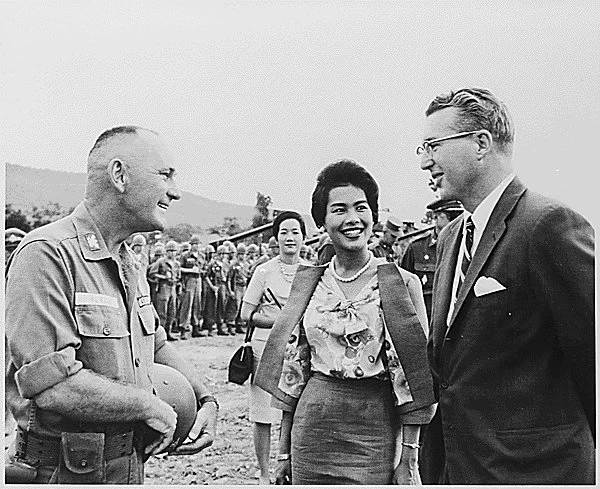 #OTD, In 1962, King Bhumibol and Queen Sirikit of Thailand visit the @USArmy's 27th Infantry \"Wolfhounds\" near Korat, Thailand. Here, Queen Sirikit visits with Colonel William McKean, Commander of the 27th, and U.S. Ambassador to Thailand, Kenneth T. Young, Jr. 