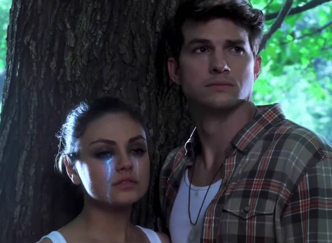 Still from Moon Quake Lake. A young couple emote under a tree. The young lady has luminous tears coming from her eyes