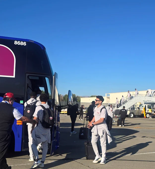 Soccer players from Team Qatar board their bus at San Jose Mineta Internationla Airport.