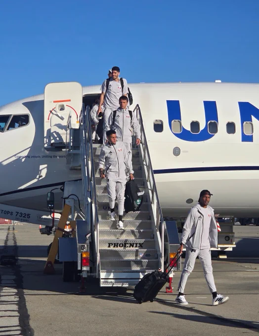 Soccer players from Team Qatar walk off their plane at San Jose Mineta International Airport.