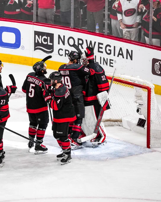 Photo of the Canes giving hugs to Brandon Bussi after the win