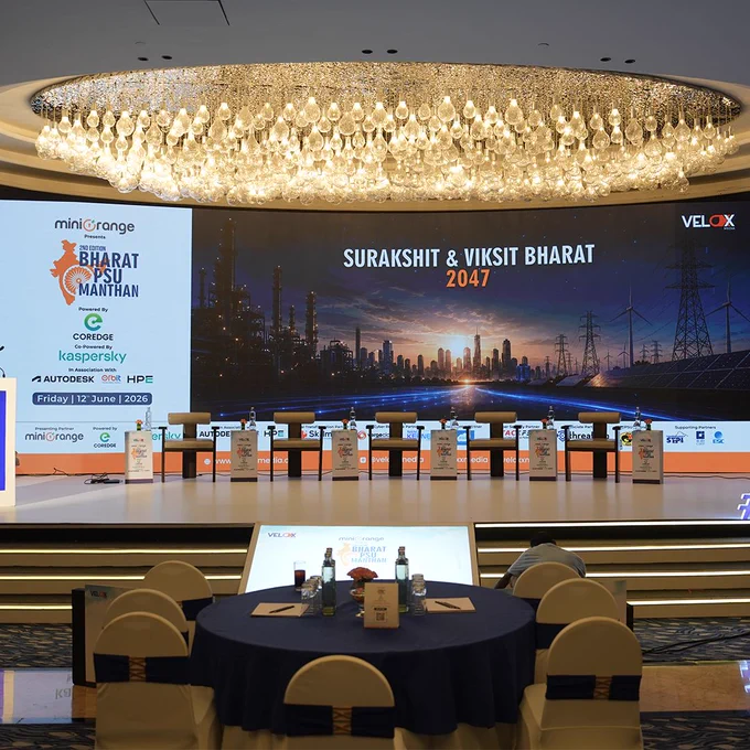 Behind-the-scenes preparations at Bharat PSU Manthan 2026 showing the stage setup, branding, production team, and venue readiness ahead of the event in New Delhi.