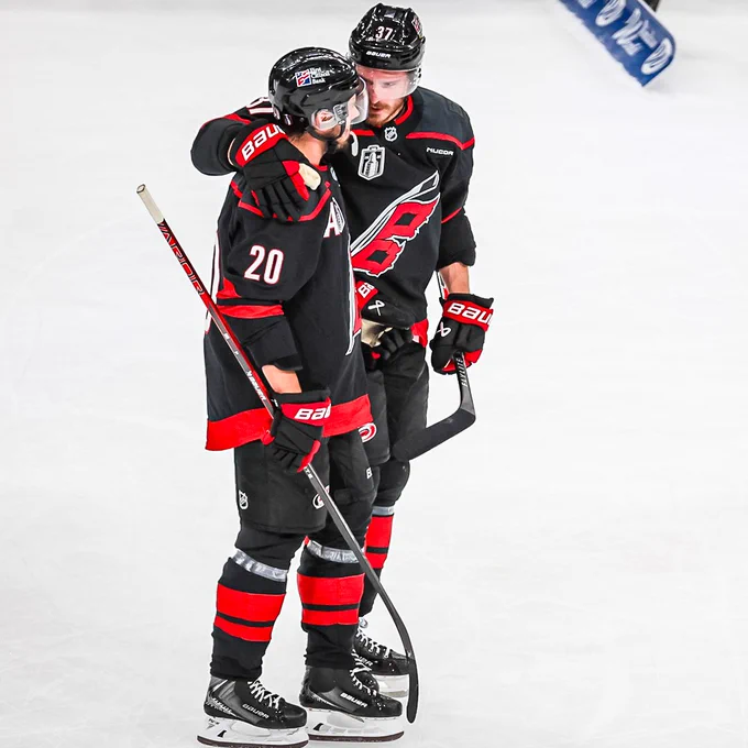 Sebastian Aho and Andrei Svechnikov embrace during tonight's win.