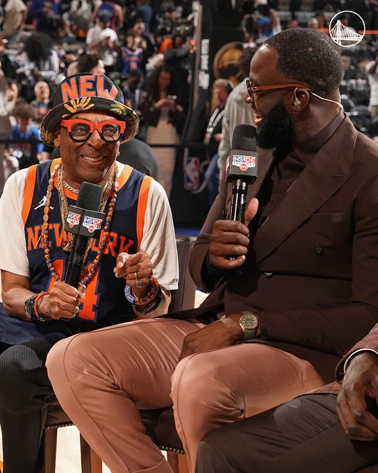 Draymond Green sits with a microphone in hand alongside Spike Lee