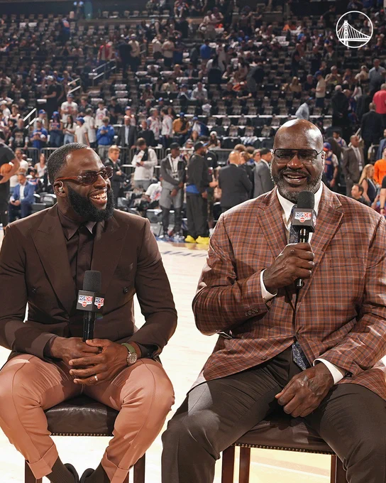 Draymond Green and Shaquille O'Neal smile with microphones in hand