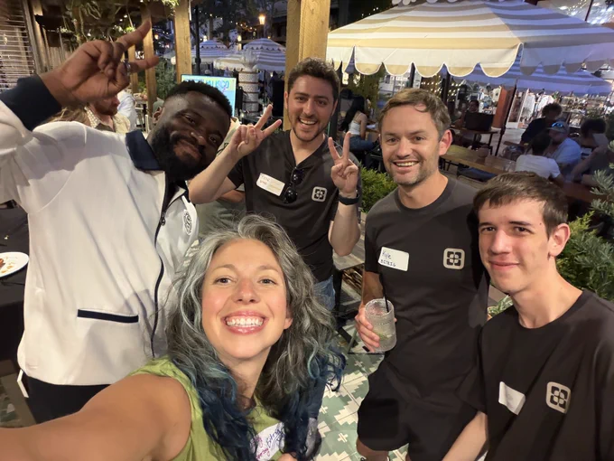 A group take a selfie and make peace signs