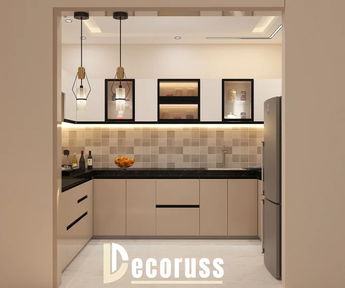 Modern U-shaped modular kitchen design featuring acrylic finish cabinets, breakfast counter, pendant lights, black countertop, glass display units, ambient LED lighting, and contemporary kitchen interiors by Decoruss Lucknow.