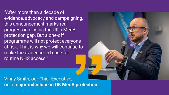 Vinny Smith, Meningitis Research Foundation Chief Executive, speaking at an event and emphasising why progress on meningitis protection must continue, holding papers and a microphone.