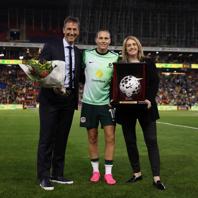 Emily van Egmond is presented with a ball and flowers to mark her becoming Australia's most-capped player.