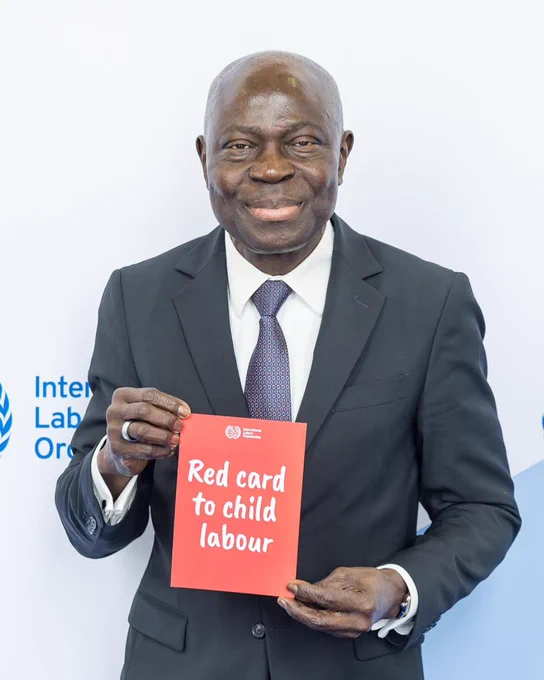 ILO Director-General, Gilbert F. Houngbo, holds up the red card to child labour on World Day Against Child Labour 2026. Photo: ILO.
