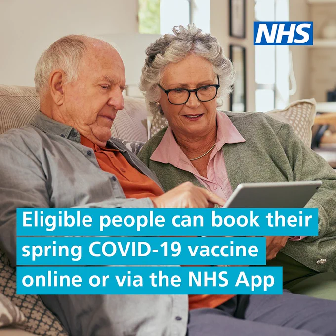 Two elderly individuals looking at a tablet with an NHS logo visible, promoting spring COVID-19 vaccine bookings.