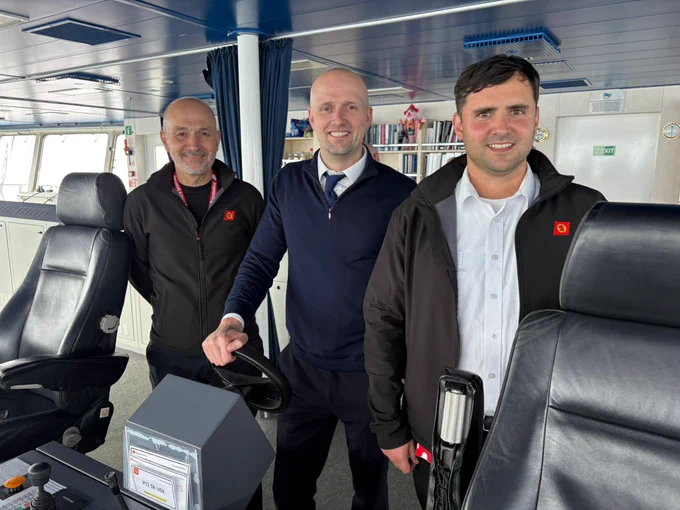 Transport Secretary Stephen Flynn poses for a photo with CalMac staff on the bridge of the MV Loch Seaforth.