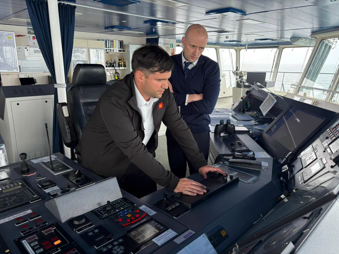 Transport Secretary Stephen Flynn is shown the controls of the MV Loch Seaforth.