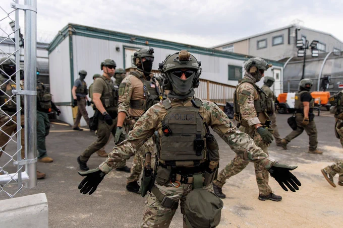 ICE officers are seen outside the Delaney Hall immigration detention facility