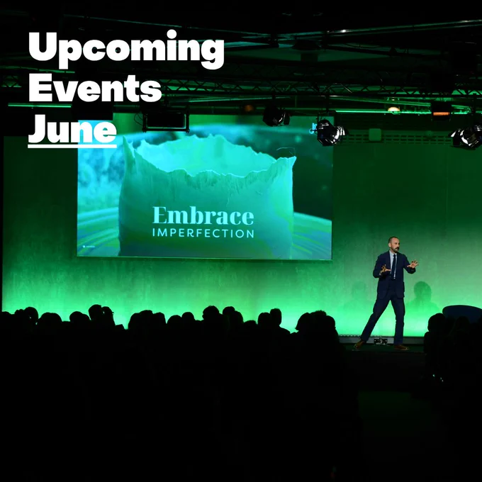 A person is speaking on stage in front of a large audience. The screen displays the text "Embrace Imperfection" with the backdrop of a green visual. The overlay text on the image says "Upcoming Events June.