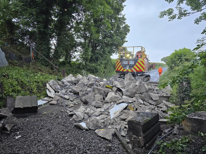 Debris on Marston Lane following bridge collision and machinery for removing the debris