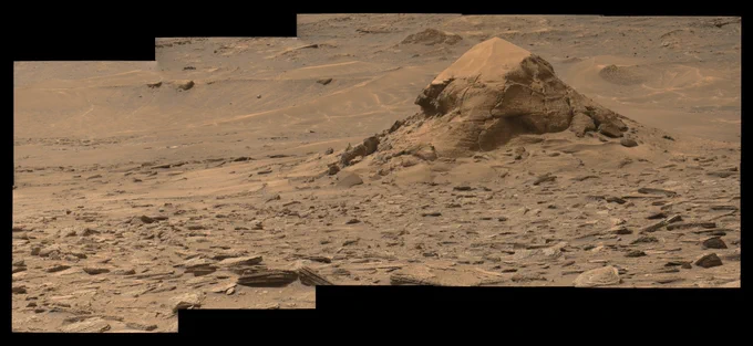 A rust toned mosaic of 10 images capturing the Mira Flores butte, a small erosional outlier standing alone in the valley currently explored by the Mars rover Curiosity on its way to the Yardang Unit.