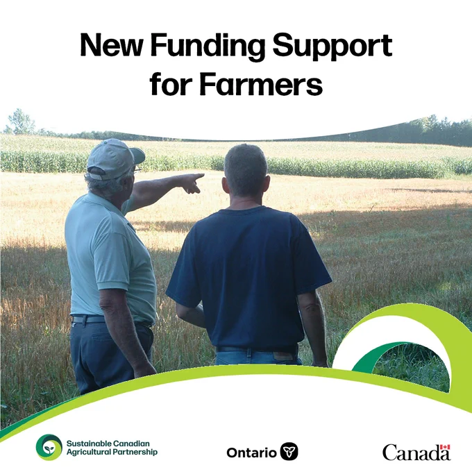 Two men in ballcaps looking out over a cornfield with backs to camera and the words “New funding support for farmers”.