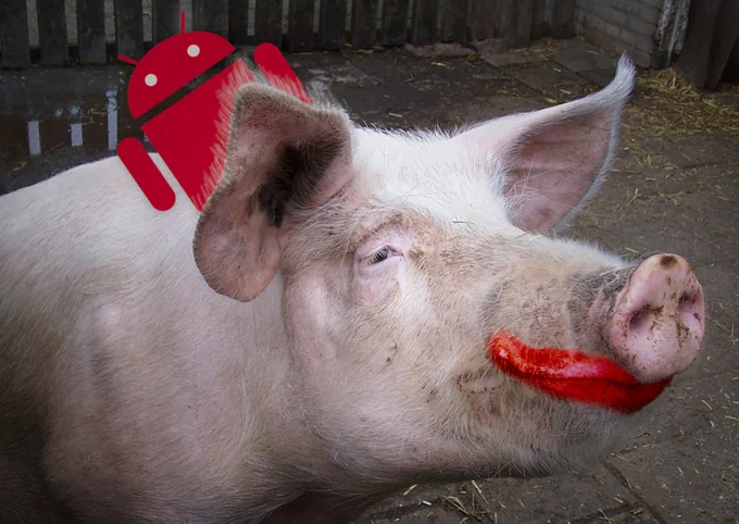 A pig in a sty. It is wearing badly applied lipstick. From behind one hairy ear pokes the Android droid.