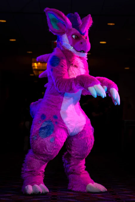 Rhubarb the pink nidorino fursuit holding up his claws