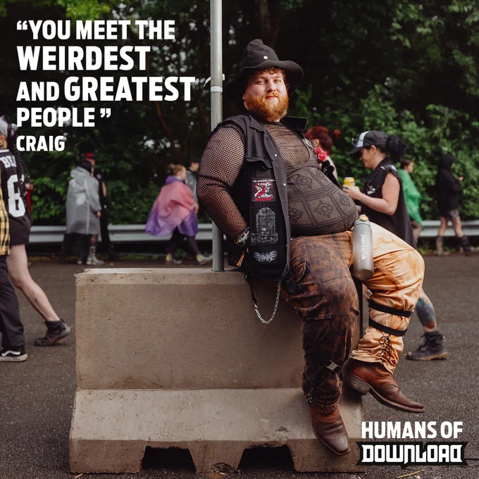 Person dressed in a brown long-sleeve top, brown trousers and black jacket leaning against a concrete barrier at Download Festival. 