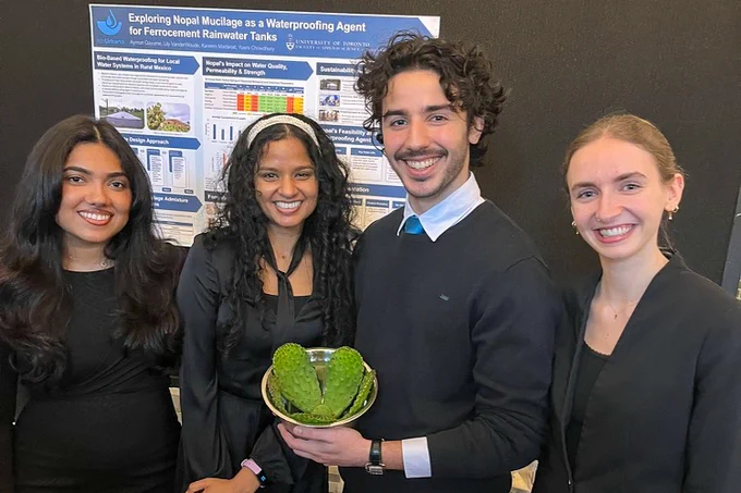 Yusra Chowdhury, Aymun Qayume, Kareem Madanat and Lily VanderWoude stand in front of a research poster at their project presentation. One person holds a bowl containing pieces of cactus. 