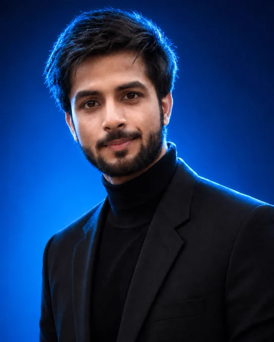 Ultra-realistic editorial portrait of a young man with tousled textured brown hair, piercing blue eyes, and a neatly groomed short beard, a black turtleneck sweater, and a tailored black blazer. Medium close-up framing, looking slightly off-camera with a calm, intelligent, confident expression. Vibrant neon lime-green seamless studio background with subtle gradient. Dramatic green rim lighting illuminating the hair, jawline, neck, and shoulders, creating a futuristic cinematic atmosphere. Professional fashion photography, luxury magazine cover aesthetic, ultra-detailed skin texture, visible pores, natural beard detail, sharp eyes, realistic reflections on glasses, high dynamic range. Soft key light from the front, subtle fill light, shallow depth of field, crisp focus on facial features, premium color grading, modern tech-founder style, minimalist composition, photorealistic, hyper-realistic, 8K, HDR, commercial advertising campaign quality. Shot on an 85mm lens, f/1.8, ISO 100, studio