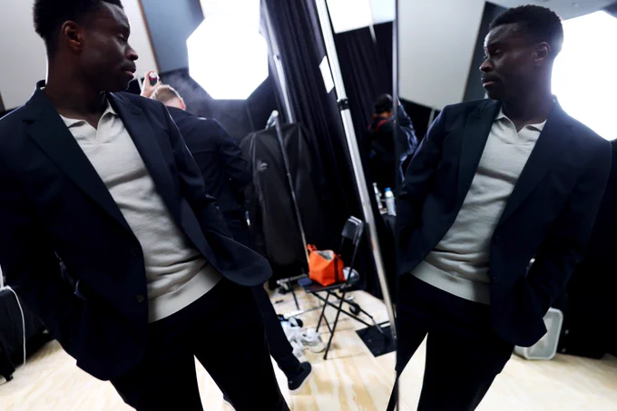 Marc Guéhi during the photoshoot, with his reflection shown in the mirror