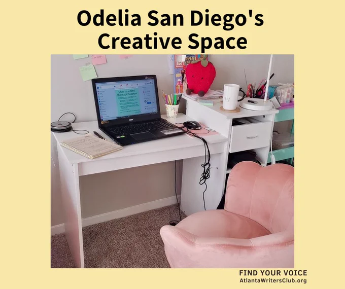 Odelia San Diego's writing desk with laptop and pink chair.
