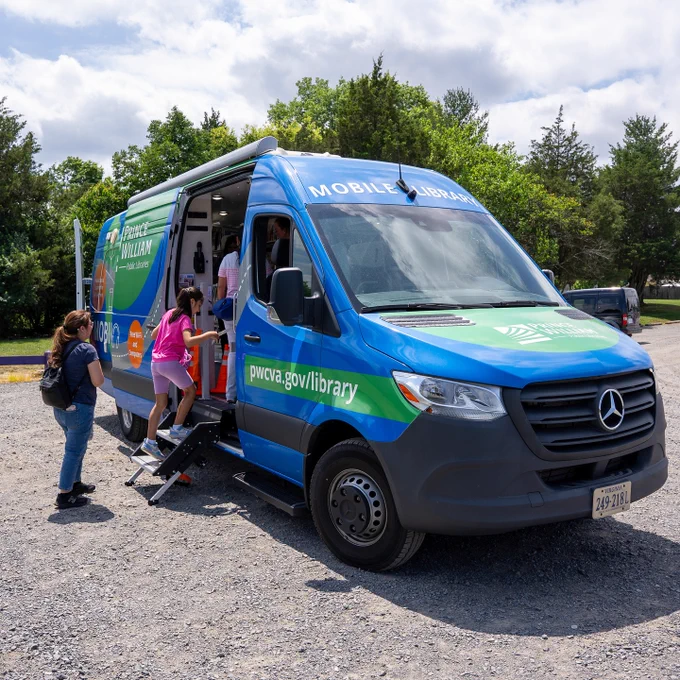 A family boards PWPL's Mobile Library.