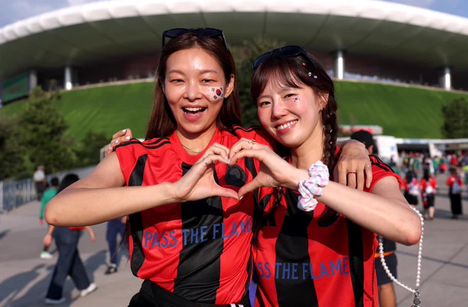 A photo of Korea Republic fans.