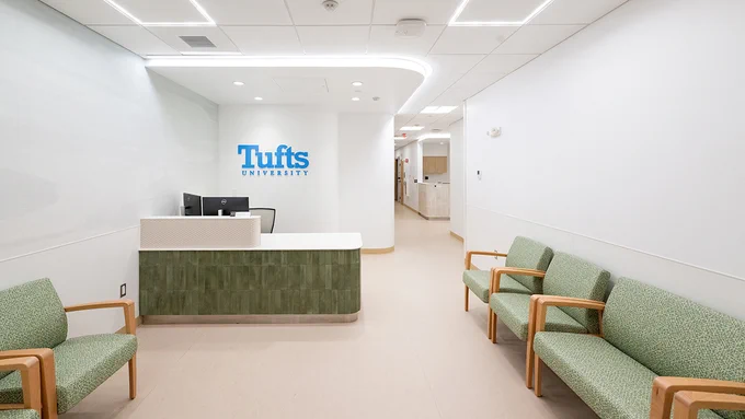 The Boston Student and Occupational Health Clinic, as seen from the lobby area with the Tufts logo behind the front desk. Photo: Alonso Nichols/Tufts University