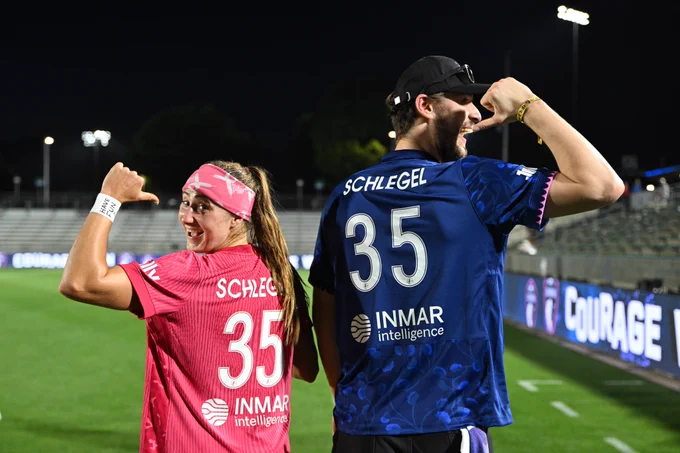 Ally Schlegel and Brandon Bussi point at their jerseys after a match