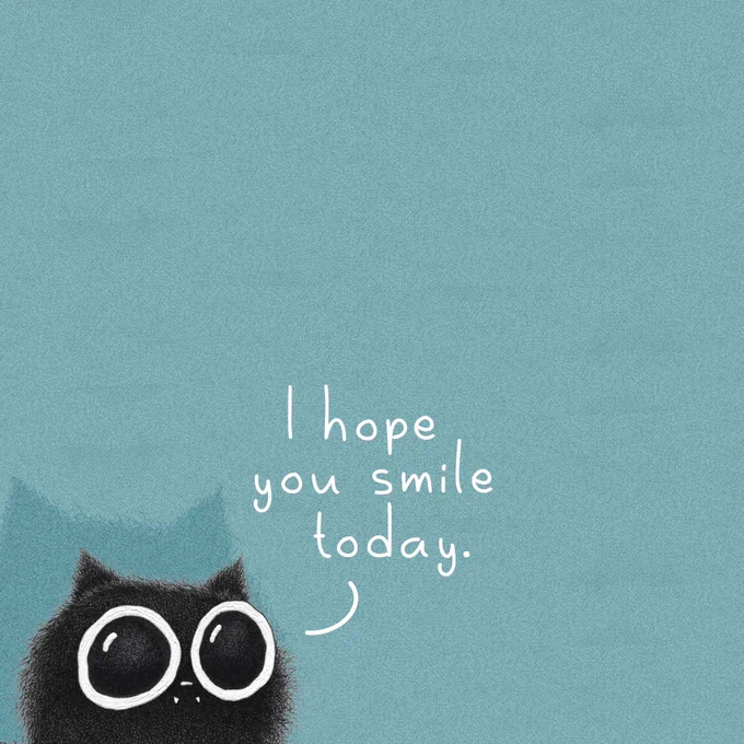A fluffy black cat with very large round eyes peeks up from the bottom left corner of a soft teal-blue background. Beside the cat, handwritten white text reads: “I hope you smile today.”
