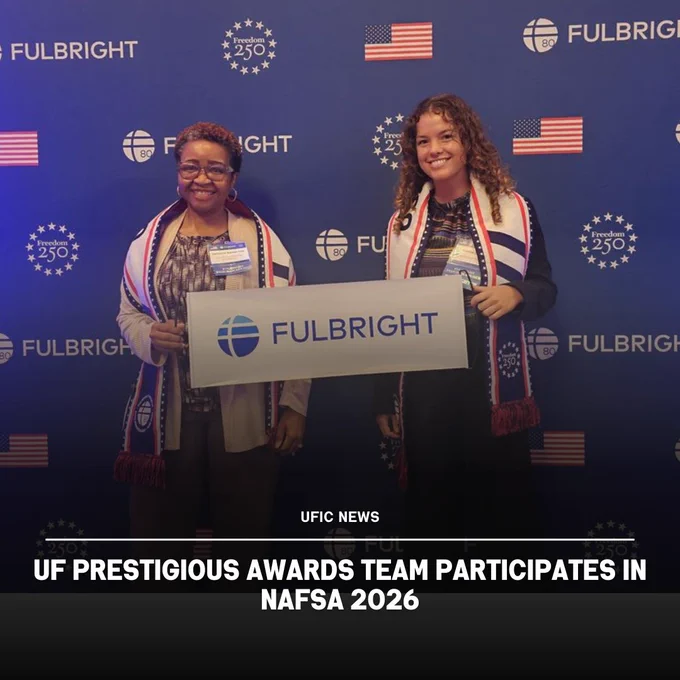 Two individuals holding a Fulbright sign at a NAFSA 2026 event with a blue backdrop featuring American flags and Fulbright logos.