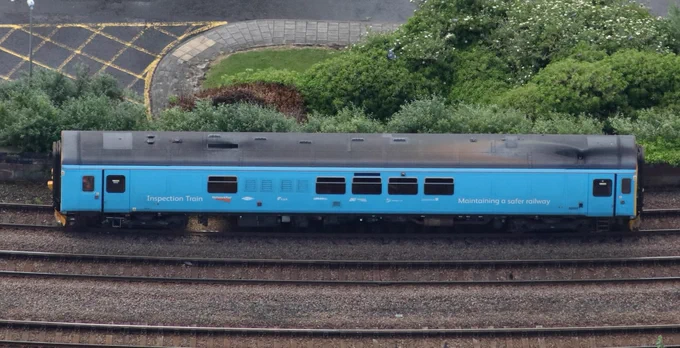 A blue train car labelled "Inspection Train" and "Maintaining a safe railway" is on the tracks. 