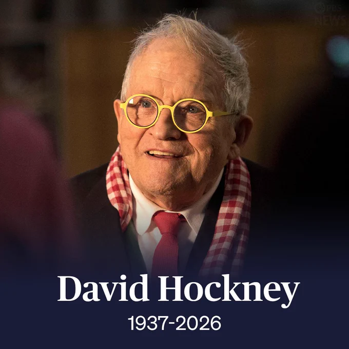 A person with yellow-framed glasses and a checkered scarf is smiling. Text below reads "David Hockney 1937-2026" with the PBS News logo.