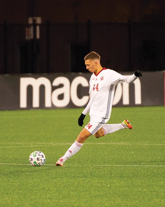 Photo of former York soccer player about to kick the soccer ball