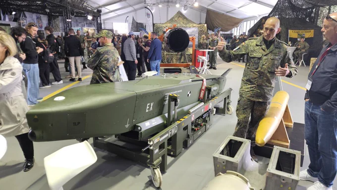A German servicemember explains the Taurus long-range strike missile, on display at the Berlin Air Show on June 12, 2026. (Breaking Defense)
